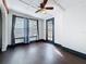 Bright bedroom featuring hardwood floors, a ceiling fan, and many windows at 4827 7Th N Ave, St Petersburg, FL 33713