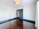 Bright bedroom featuring white walls, wood floors, and doors with dark trim at 4827 7Th N Ave, St Petersburg, FL 33713