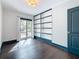 Bedroom with hardwood floors, built-in shelves, and a door leading to the outside at 4827 7Th N Ave, St Petersburg, FL 33713