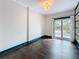 Bright room with wood floors, built-in bookshelves, and glass doors leading outside at 4827 7Th N Ave, St Petersburg, FL 33713