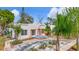 Inviting single-Gathering home with a textured stucco exterior, vibrant orange accents, and lush landscaping at 4827 7Th N Ave, St Petersburg, FL 33713