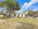 A home with an expansive front yard with large trees and various vegetation at 4827 7Th N Ave, St Petersburg, FL 33713