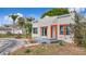 Cozy single-story home featuring a stucco exterior, eye-catching orange window trim, and a quaint front yard at 4827 7Th N Ave, St Petersburg, FL 33713