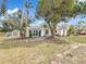 Exterior shot of the home with mature landscaping, patio and partially shaded yard at 4827 7Th N Ave, St Petersburg, FL 33713