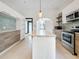 Bright kitchen features stainless steel appliances, island, and stylish two-tone cabinetry at 4827 7Th N Ave, St Petersburg, FL 33713