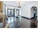 Open-concept living room with polished wood floors, elegant lighting, and arched doorways leading to other spaces at 4827 7Th N Ave, St Petersburg, FL 33713