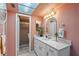 Bright bathroom featuring a skylight, walk-in shower, and white vanity with mirror at 4900 38Th S Way # 304, St Petersburg, FL 33711