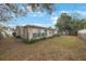 Lush backyard with green grass and plants around the exterior of the home at 5317 Tammy Ln, Holiday, FL 34690