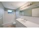 Bathroom with a vanity, large mirror, and shower-tub, offering ample space and comfort at 5317 Tammy Ln, Holiday, FL 34690