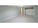 A bedroom with Terrazzo flooring, a ceiling fan, and a closet, plus a glimpse into the bathroom at 5317 Tammy Ln, Holiday, FL 34690
