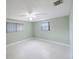 Bright bedroom features terrazzo flooring, a ceiling fan, and two windows letting in plenty of light at 5317 Tammy Ln, Holiday, FL 34690