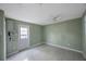 Bedroom featuring tile flooring and a back door, providing access to the yard at 5317 Tammy Ln, Holiday, FL 34690