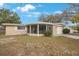 Charming single-story home with a screened porch and attached one-car garage at 5317 Tammy Ln, Holiday, FL 34690