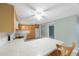 Kitchen with breakfast bar area, wood cabinetry, white appliances and pantry, open layout design at 5317 Tammy Ln, Holiday, FL 34690