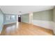 Bright and airy living room with laminate flooring, large windows, and a freshly painted interior at 5317 Tammy Ln, Holiday, FL 34690