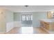 Living area showcasing laminate flooring, open access to the kitchen, and screened porch at 5317 Tammy Ln, Holiday, FL 34690