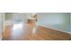 Spacious living room with laminate floors, seamlessly leading to the kitchen and screened porch at 5317 Tammy Ln, Holiday, FL 34690