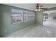 Enclosed sunroom has bright windows offering views of the outdoors and tiled flooring at 5317 Tammy Ln, Holiday, FL 34690