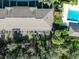 An aerial of screened patios and a pool with lush green landscaping and plenty of trees at 5712 Fishhawk Ridge Dr, Lithia, FL 33547