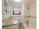 Bathroom featuring granite countertop and tiled bath and shower at 6800 Sunset Way # 1003, St Pete Beach, FL 33706