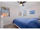 Bright bedroom features natural light, a ceiling fan, and views of a palm tree at 6800 Sunset Way # 1003, St Pete Beach, FL 33706