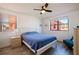 Sunlit bedroom featuring a comfortable bed, wood-look flooring, and view of the neighborhood at 6800 Sunset Way # 1003, St Pete Beach, FL 33706