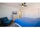 Comfortable bedroom featuring a ceiling fan, dresser, and a cozy armchair at 6800 Sunset Way # 1003, St Pete Beach, FL 33706