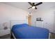 Bedroom features a ceiling fan, dresser, and a nightstand with a lamp at 6800 Sunset Way # 1003, St Pete Beach, FL 33706