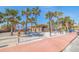 Picturesque beach access with palm trees and a charming building at 6800 Sunset Way # 1003, St Pete Beach, FL 33706