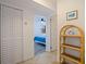Hallway view of bedroom and a small decorative shelf at 6800 Sunset Way # 1003, St Pete Beach, FL 33706