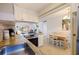 Bright kitchen and dining area featuring stainless steel appliances, granite countertops, and open concept at 6800 Sunset Way # 1003, St Pete Beach, FL 33706