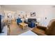 Cozy living room featuring tiled floors, modern furnishings, and an open view to the dining and kitchen area at 6800 Sunset Way # 1003, St Pete Beach, FL 33706