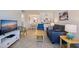 Bright living room with tiled flooring, modern furniture, open to the dining area and kitchen at 6800 Sunset Way # 1003, St Pete Beach, FL 33706