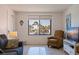 Living room with tile floors, a comfortable seating area, and a beach view from the window at 6800 Sunset Way # 1003, St Pete Beach, FL 33706
