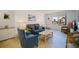 Bright living room featuring tile floors, modern furniture, and a beach view from the window at 6800 Sunset Way # 1003, St Pete Beach, FL 33706