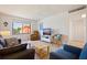 Comfortable living room with coastal decor, including a large window view and white shiplap walls at 6800 Sunset Way # 1003, St Pete Beach, FL 33706