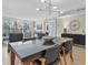 Dining area featuring a modern light fixture, balcony access and sliding door to another room at 700 Beach Ne Dr # 405, St Petersburg, FL 33701