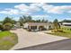 Aerial view showcasing the property with its well-manicured lawn, long driveway, and charming curb appeal at 829 E 4Th St, Englewood, FL 34223