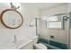 Bathroom featuring a white tile backsplash, wood-trimmed mirror, and blue tub at 829 E 4Th St, Englewood, FL 34223