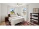 Bright bedroom with neutral color scheme, ceiling fan, and outdoor views at 829 E 4Th St, Englewood, FL 34223