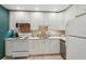 Modern kitchen with white cabinetry, a trendy backsplash, and stainless-steel appliances at 829 E 4Th St, Englewood, FL 34223