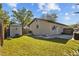 A partial view of the home's exterior and backyard featuring a storage shed and lawn at 843 Queensboro S Ave, St Petersburg, FL 33701