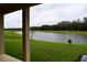 Serene backyard view overlooking a tranquil pond and lush green space, offering a peaceful retreat at 8438 Wheat Stone Dr, Zephyrhills, FL 33540