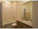 Well-lit bathroom with shower, tub and granite vanity top at 8438 Wheat Stone Dr, Zephyrhills, FL 33540