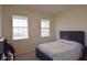 Bright bedroom with large windows, a comfortable bed, and neutral décor, creating a relaxing atmosphere at 8438 Wheat Stone Dr, Zephyrhills, FL 33540