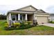 Inviting single-story home with a beautifully landscaped front yard and stone-accented columns, offering a warm welcome at 8438 Wheat Stone Dr, Zephyrhills, FL 33540