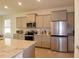 Modern kitchen with stainless steel appliances and granite countertops at 8438 Wheat Stone Dr, Zephyrhills, FL 33540