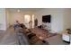 Spacious living room with tile flooring, a comfortable seating area, and natural light, perfect for relaxation at 8438 Wheat Stone Dr, Zephyrhills, FL 33540