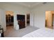 Bright main bedroom featuring a walk-in closet, ensuite bath, and connecting living space at 8438 Wheat Stone Dr, Zephyrhills, FL 33540