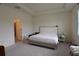 Comfortable main bedroom featuring a bed with white quilted comforter and an ensuite bathroom at 8438 Wheat Stone Dr, Zephyrhills, FL 33540